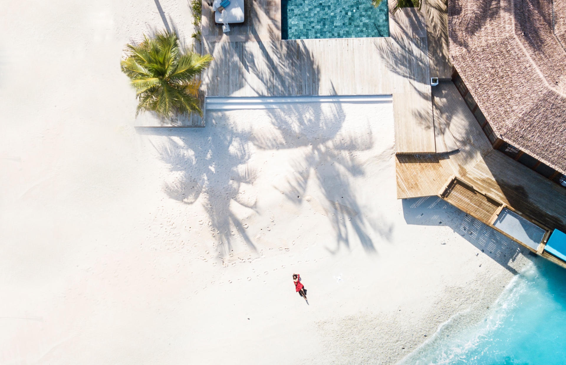 A seaside beach villa is pictured from an aerial view.