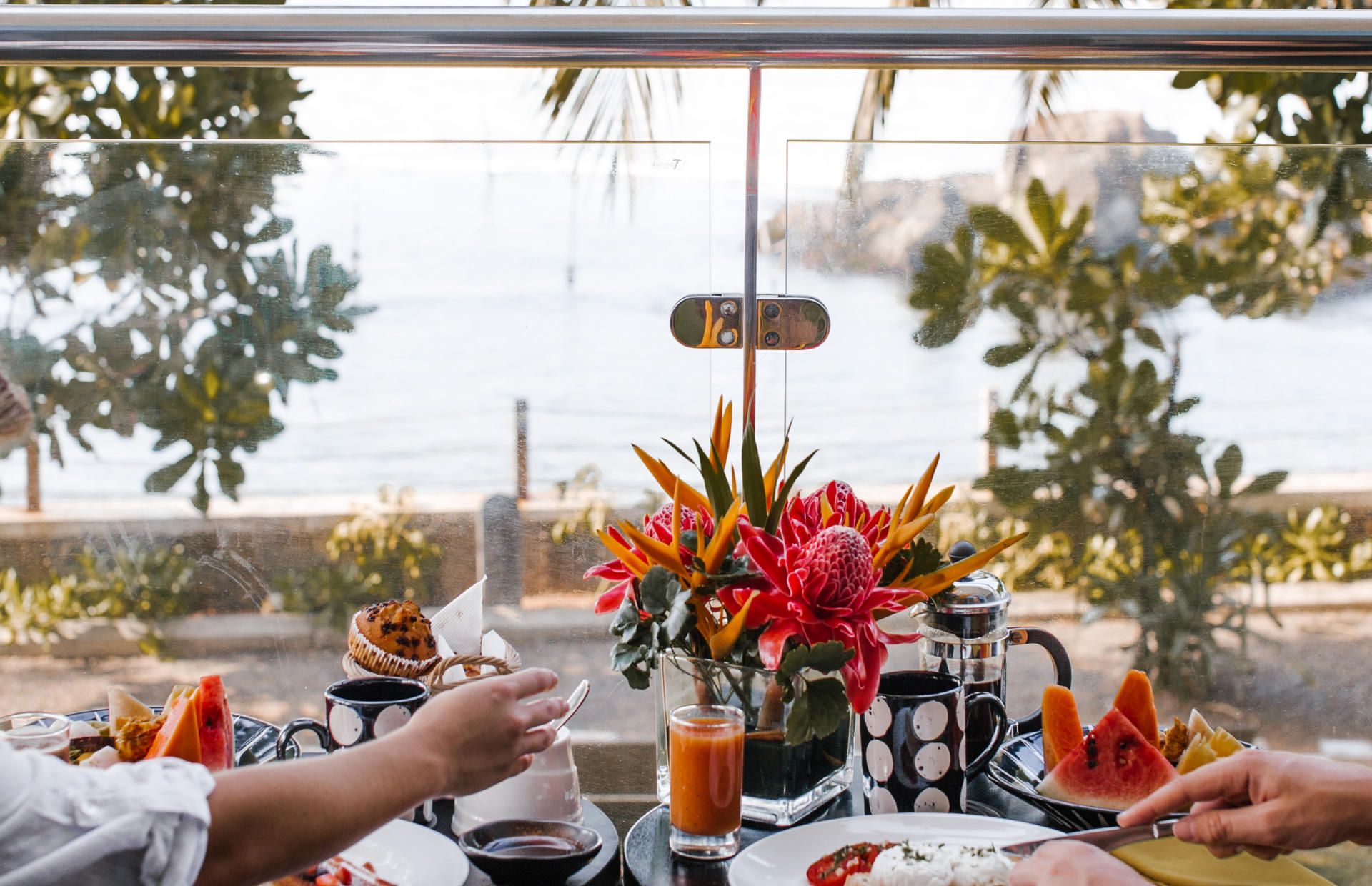 Two hotel guests sit at a table and enjoy a meal.