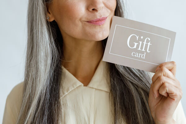 woman-holding-gift-card Woman holding gift card